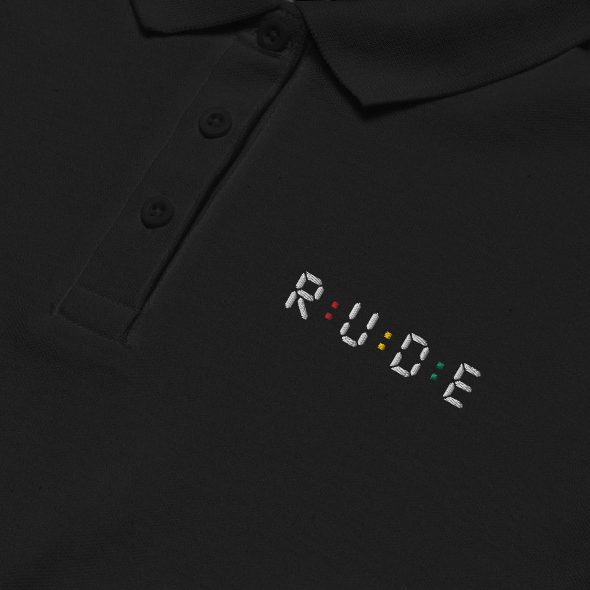 Black women’s pique polo shirt showing fabric, fit and embroidered logo details.