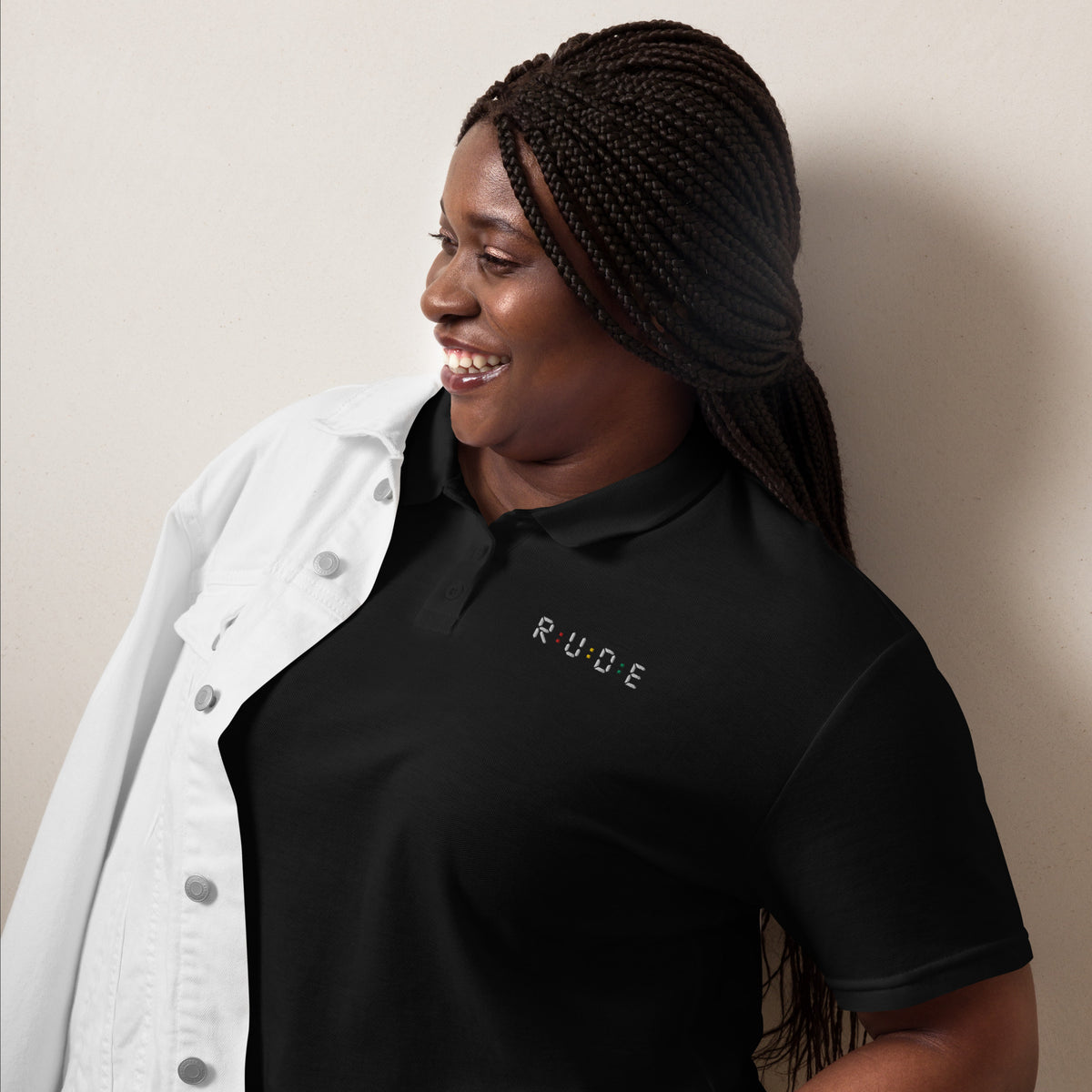 Black women’s pique polo shirt with embroidered Rude logo and red, gold and green details